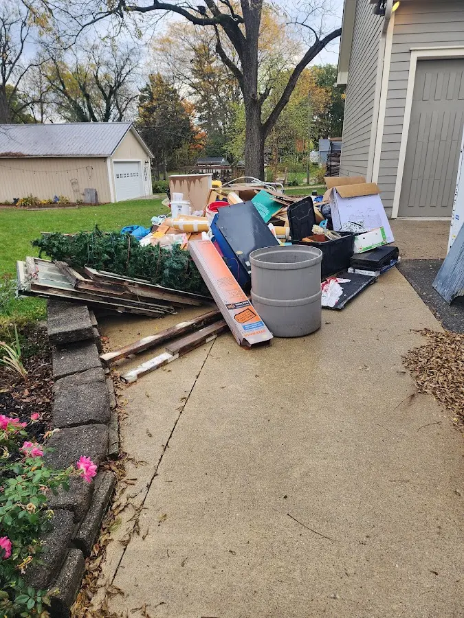 Dumpster being loaded with debris for Estate Cleanout Dumpster Rental in Smithville